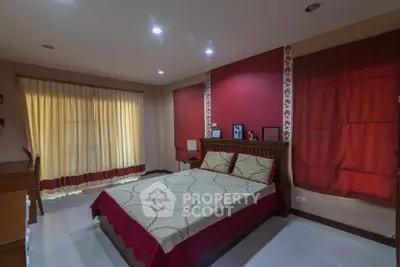 Cozy bedroom with elegant red accents and ambient lighting