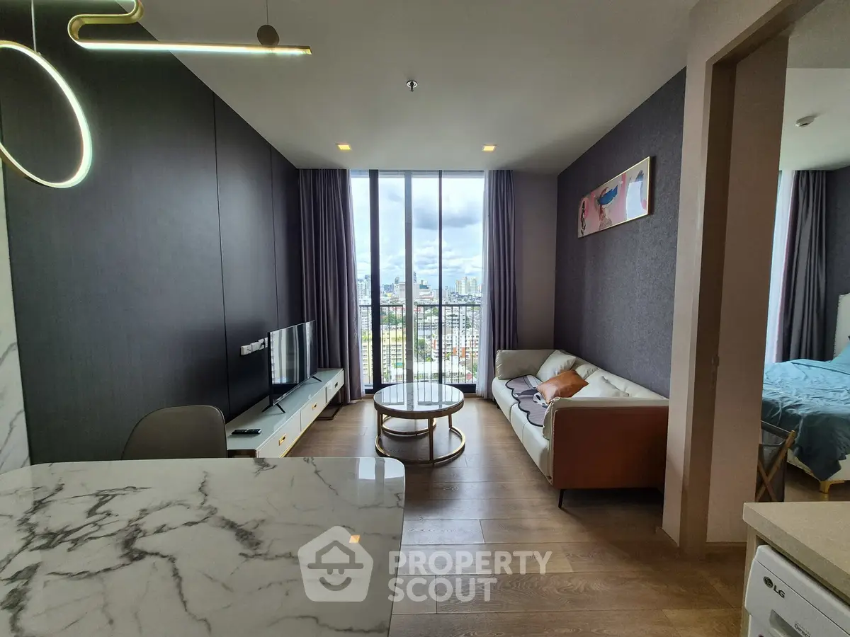 Modern living room with city view, stylish furniture, and elegant lighting