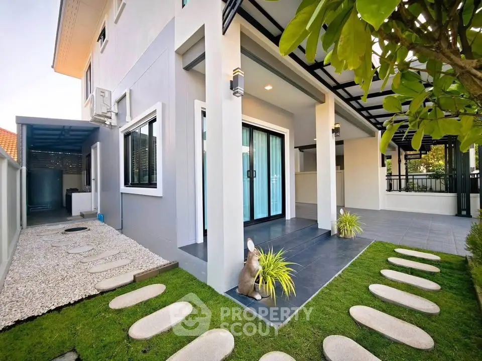 Modern two-story house with stylish exterior and landscaped garden path