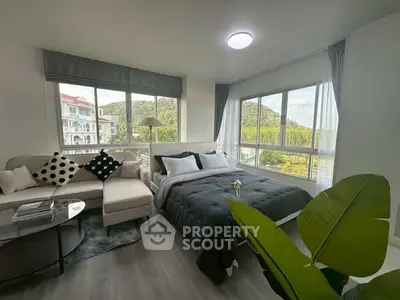 Modern living room with cozy bed and scenic window view