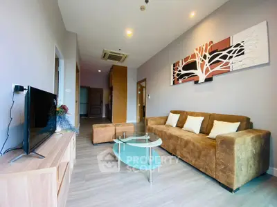 Spacious modern living room with stylish decor and comfortable seating in a contemporary apartment.