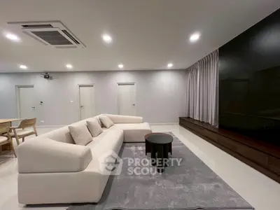 Spacious modern living room with sleek furniture and ambient lighting