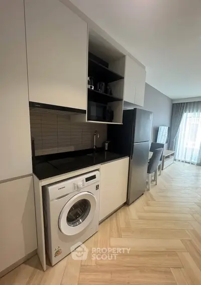 Modern kitchen with sleek appliances and open layout in a stylish apartment.