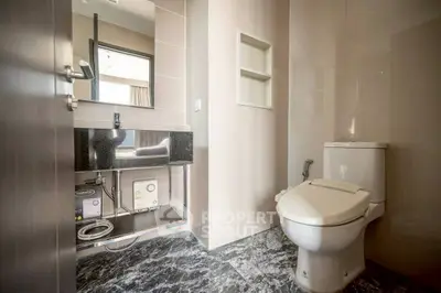 Modern bathroom with sleek design and marble flooring in a contemporary apartment.