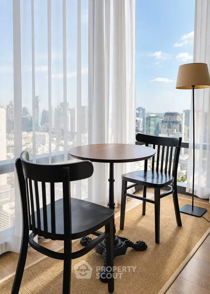 Chic urban apartment with stunning city view and cozy seating area.