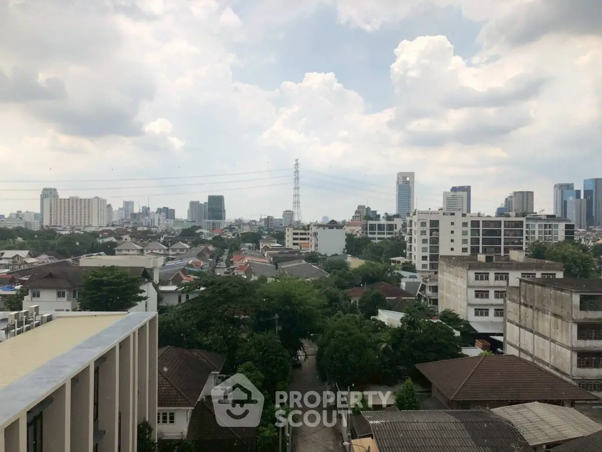 Stunning cityscape view showcasing urban skyline and residential area with lush greenery.