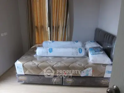 Spacious bedroom with new mattress and elegant curtains in modern apartment.