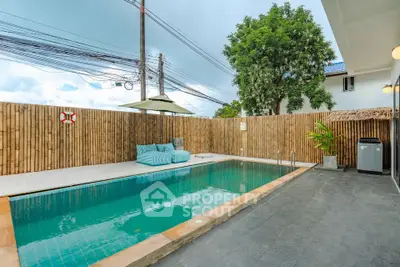 Stunning private pool area with modern seating and bamboo fencing