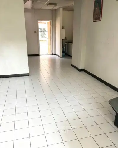 Spacious interior with tiled flooring and natural light, ideal for customization.