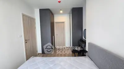 Modern bedroom with sleek design and ample storage in a contemporary apartment.