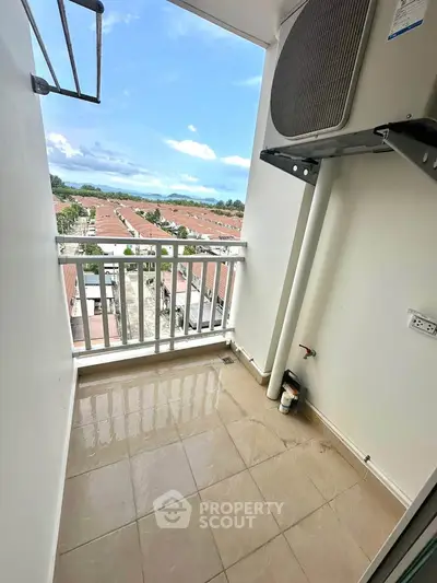 Charming balcony with scenic view of rooftops and sky, perfect for relaxation.