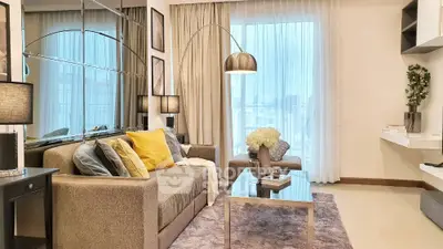 Modern living room with stylish decor and large windows offering city views