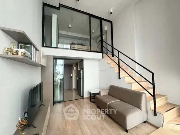 Modern loft-style living room with mezzanine, sleek staircase, and minimalist decor.