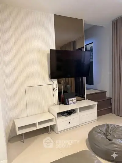 Modern living room with wall-mounted TV and stylish decor