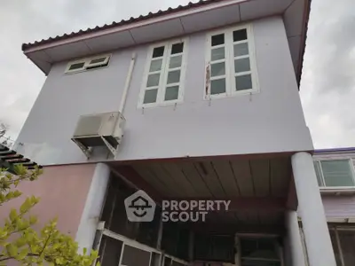 Charming two-story house with unique architectural design and spacious windows, perfect for modern living.