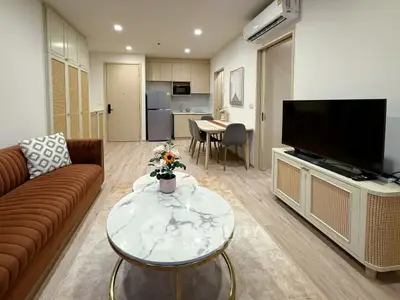 Modern living room with stylish furniture and open kitchen layout in a cozy apartment.