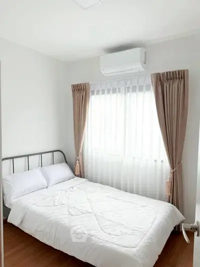 Cozy bedroom with natural light and modern air conditioning unit