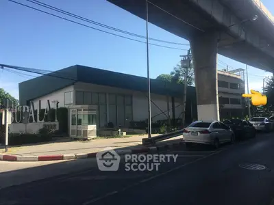 Modern commercial building exterior with parking and street view