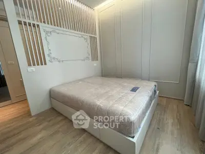 Modern bedroom with elegant design and cozy atmosphere, featuring a stylish bed and wooden flooring.