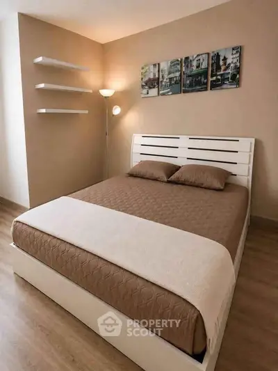 Modern bedroom with stylish decor and cozy ambiance, featuring a comfortable bed and elegant wall art.