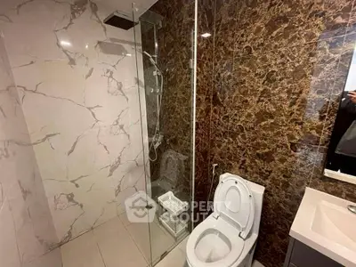 Luxurious bathroom with marble walls and modern shower design