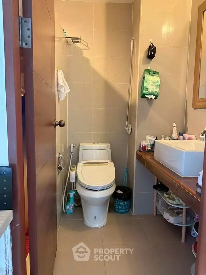 Compact bathroom with modern fixtures and ample storage space