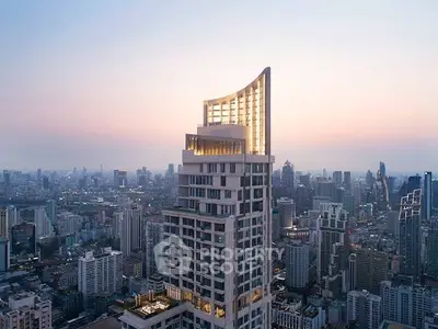 Stunning cityscape view featuring a modern high-rise building at sunset.