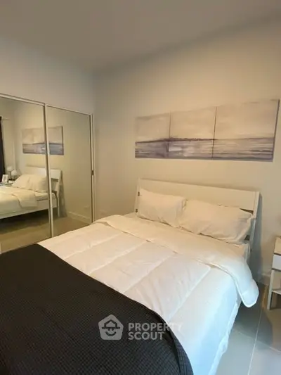 Cozy bedroom with modern decor and mirrored closet doors