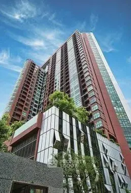Stunning modern high-rise building with lush greenery and sleek architectural design.