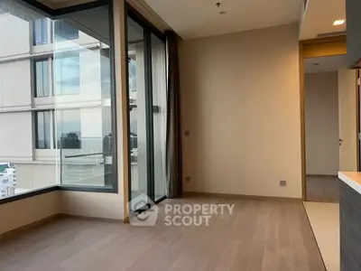 Spacious corner unit with floor-to-ceiling windows and city view, perfect for modern living.