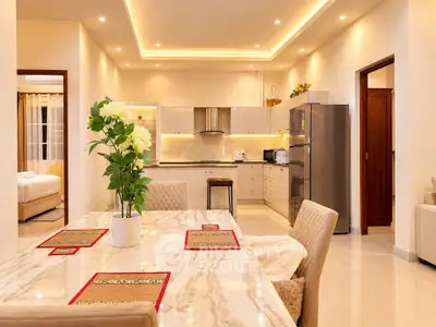 Luxurious open-layout kitchen and dining area with modern appliances and elegant decor.