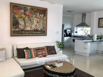 Stylish open-layout living room with modern kitchen and elegant decor