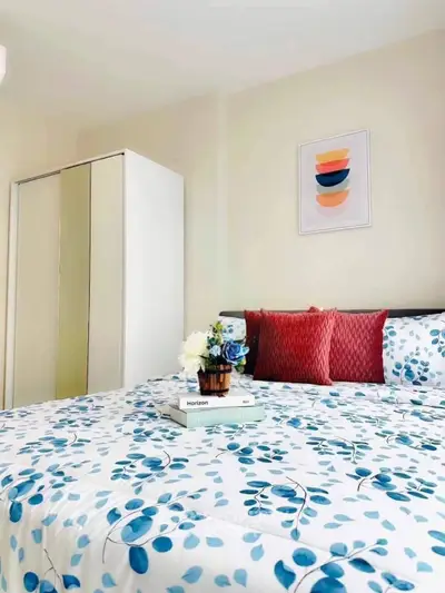 Charming bedroom with floral bedding and modern decor, perfect for a cozy retreat.