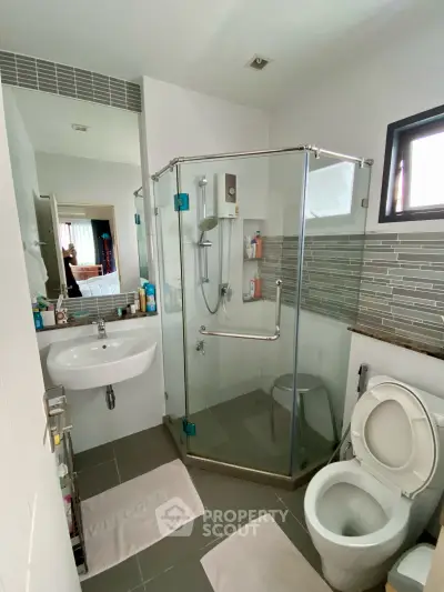 Modern bathroom with glass shower enclosure and sleek design