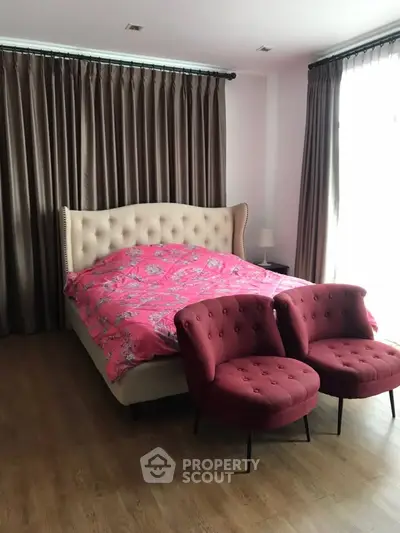 Spacious bedroom with elegant bed and cozy seating area