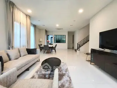 Spacious modern living room with elegant decor and open dining area