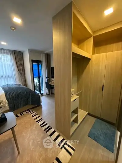 Modern bedroom with stylish decor and built-in storage, featuring a cozy ambiance and natural light.