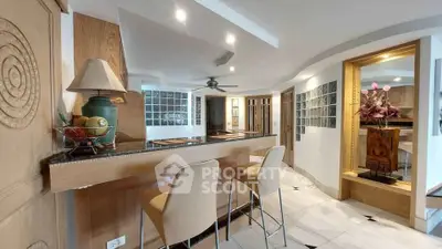 Luxurious modern kitchen with elegant bar seating and stylish decor