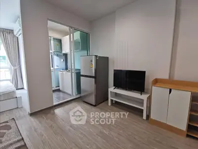 Modern apartment interior with open layout, featuring a compact kitchen and cozy living area.