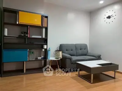 Modern living room with stylish shelving and comfortable sofa, perfect for relaxation and entertainment.