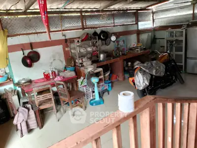 Rustic kitchen with eclectic decor and motorcycle storage, showcasing unique living space.