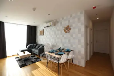 Modern living room with stylish decor and dining area in a bright apartment