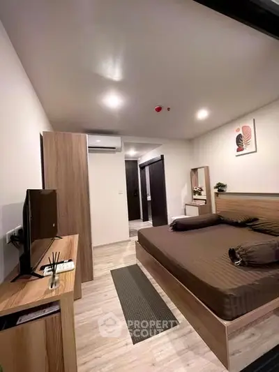 Modern bedroom with sleek furniture and stylish decor in a contemporary apartment.