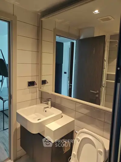 Modern bathroom with sleek sink and mirror in contemporary apartment