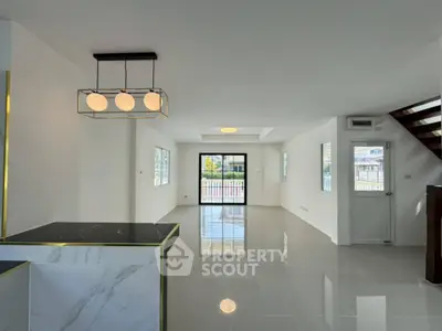 Spacious modern living room with elegant lighting and glossy floors