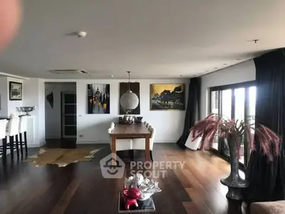 Spacious modern living room with elegant decor and large windows.