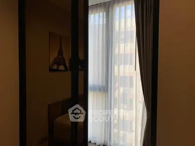 Cozy bedroom with elegant curtains and soft lighting, perfect for relaxation.
