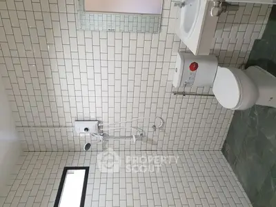 Modern bathroom with white subway tiles and sleek fixtures.