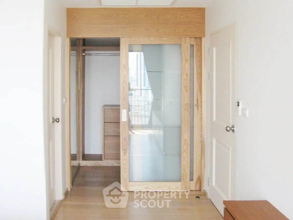 Spacious walk-in closet with sliding glass door in modern apartment