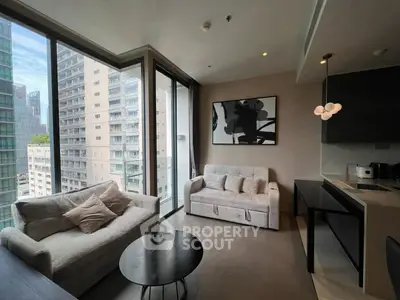 Modern living room with large windows and city view, featuring stylish furniture and open kitchen layout.